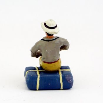 afrikaner assis sur paquetage