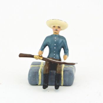 cow-boy assis sur paquetage