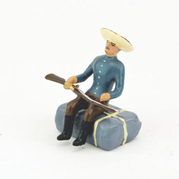 cow-boy assis sur paquetage