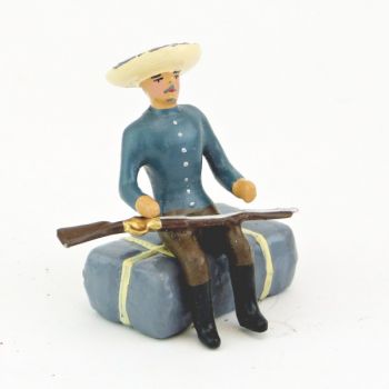 cow-boy assis sur paquetage